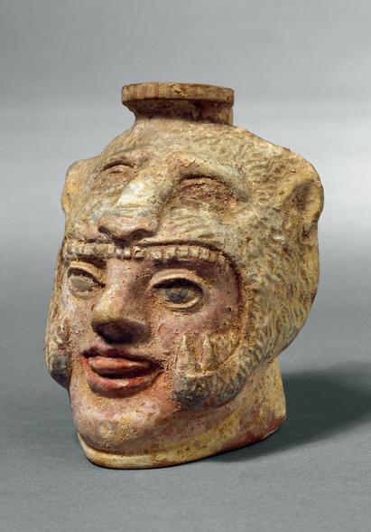 Salveflaske, såkaldt arybal, udformet som Herakleshoved iført løveskind, fremstillet i Korinth 575-550 f.Kr.