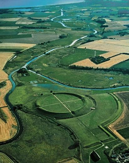 Trelleborg. Den geometriske opbygning er tydelig. På billedet ses også hvordan Trelleborg ligger taktisk velplaceret, omgivet af svært tilgængelige vådområder. Den side, der har været vendt mod det tørre land og derfor har været mest sårbar, er blevet forstærket med en forborg - en ekstra vold. Foto: Gyldendal Trelleborgene