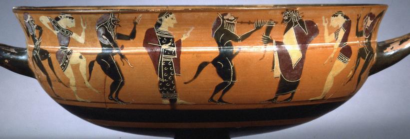 Græsk drikkeskål med satyrer og mænader omkring vinguden Dionysos, som holder et drikkehorn. 550-530 f.Kr.